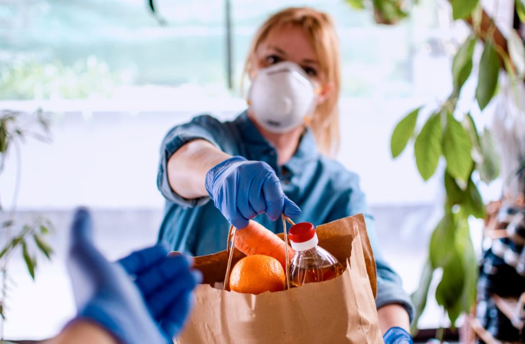 Woman wearing a mask to deliver food during COVID-19