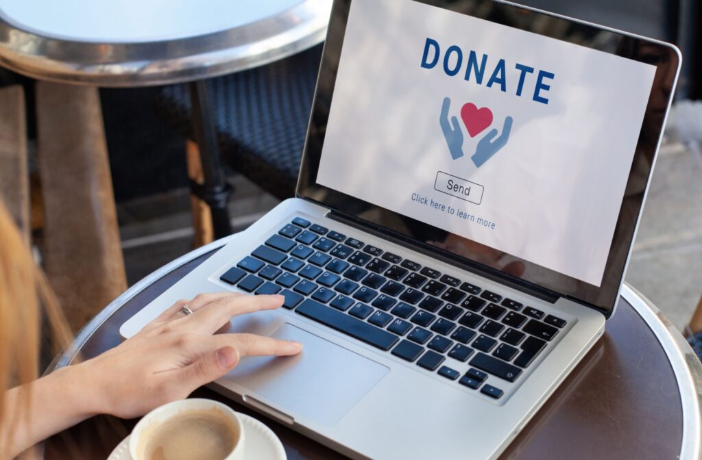 A person makes an online charitable contribution to a local cause.